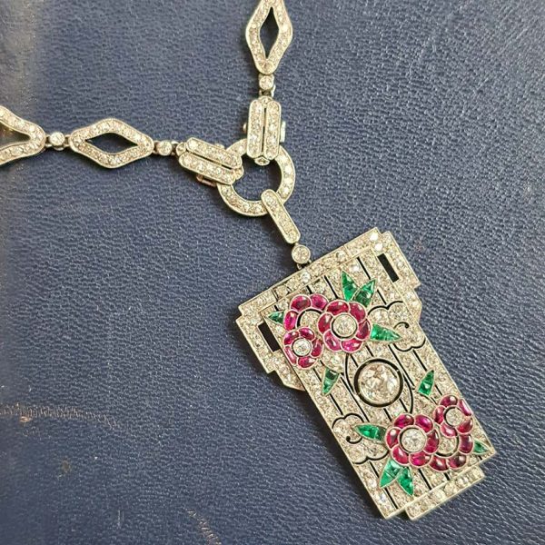 Art Deco Ruby Emerald Diamond Pendant Sautoir Necklace in Platinum, diamond sautoir necklace of alternating sized diamond-shaped links set with single-cut diamonds leading to detachable diamond, ruby and emerald set floral plaque pendant. Circa 1925