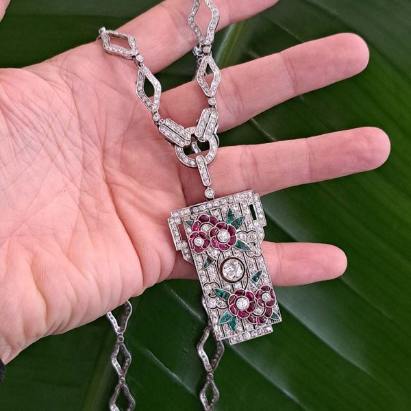 Art Deco Ruby Emerald Diamond Pendant Sautoir Necklace in Platinum, diamond sautoir necklace of alternating sized diamond-shaped links set with single-cut diamonds leading to detachable diamond, ruby and emerald set floral plaque pendant. Circa 1925