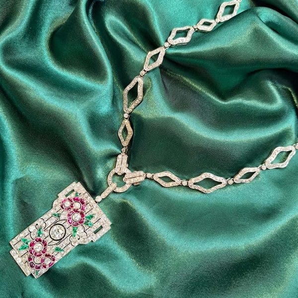 Art Deco Ruby Emerald Diamond Pendant Sautoir Necklace in Platinum, diamond sautoir necklace of alternating sized diamond-shaped links set with single-cut diamonds leading to detachable diamond, ruby and emerald set floral plaque pendant. Circa 1925