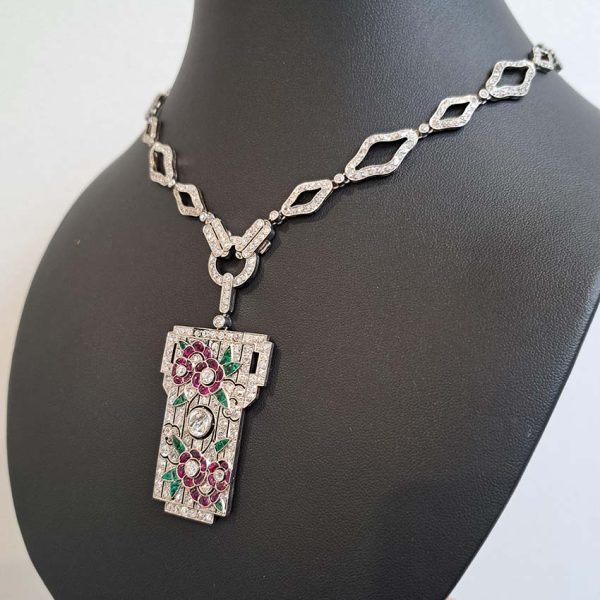 Art Deco Ruby Emerald Diamond Pendant Sautoir Necklace in Platinum, diamond sautoir necklace of alternating sized diamond-shaped links set with single-cut diamonds leading to detachable diamond, ruby and emerald set floral plaque pendant. Circa 1925