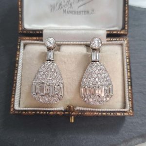 Late Art Deco 5ct Diamond Drop Earrings, old cut diamond solitaire tops suspend pear shaped drops with baguette-cut diamond bands in 18ct white gold