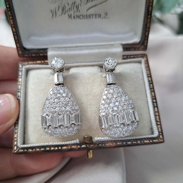 Late Art Deco 5ct Diamond Drop Earrings, old cut diamond solitaire tops suspend pear shaped drops with baguette-cut diamond bands in 18ct white gold