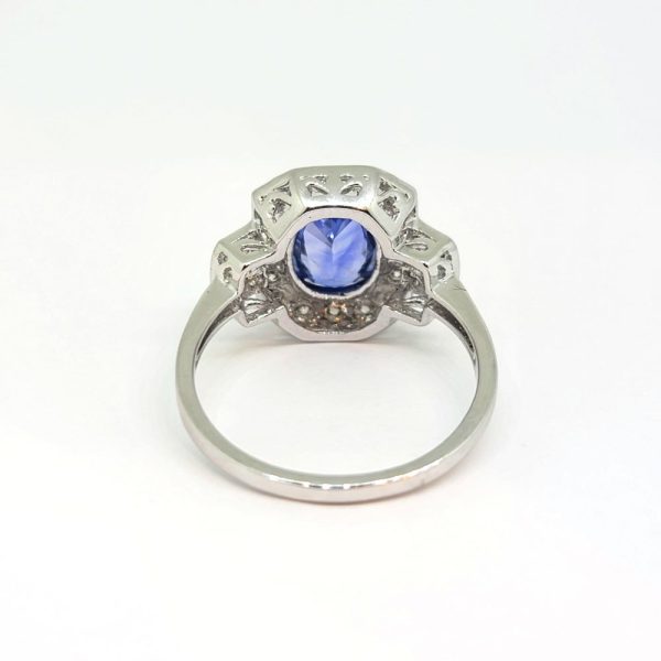 2ct Oval Sapphire and Diamond Cluster Ring, 2.02ct oval blue sapphire surrounded by diamonds with diamond buckle design shoulders