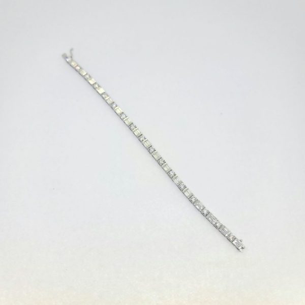 6.40ct Baguette and Brilliant Cut Diamond Line Tennis Bracelet, set with 6.40 carats of round brilliant-cut and baguette-cut diamonds in 18ct white gold. 17cm