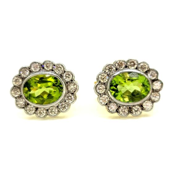 2.50ct Oval Peridot and Diamond Floral Cluster Earrings, oval peridots surrounded by round brilliant-cut diamonds in an elegant flower design in 18ct gold