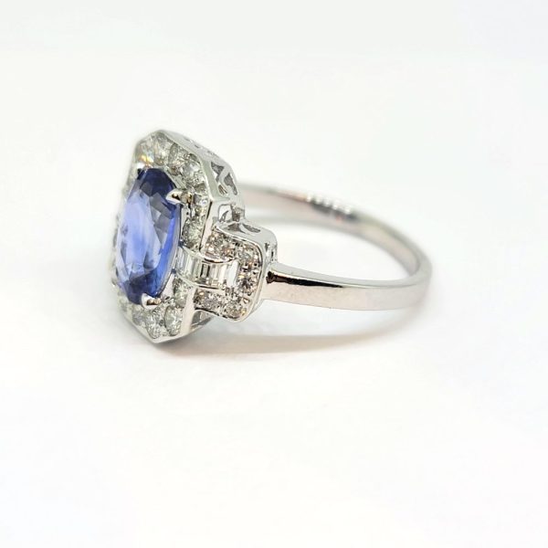 2ct Oval Sapphire and Diamond Cluster Ring, 2.02ct oval blue sapphire surrounded by diamonds with diamond buckle design shoulders