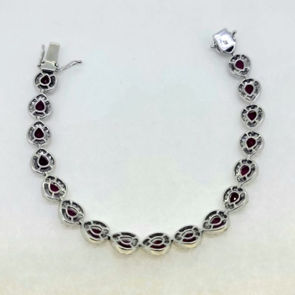 13cts Ruby and Diamond Cluster Bracelet, 13.00 carats of rubies each surrounded by a halo of sparkling round brilliant-cut diamonds in 18ct white gold