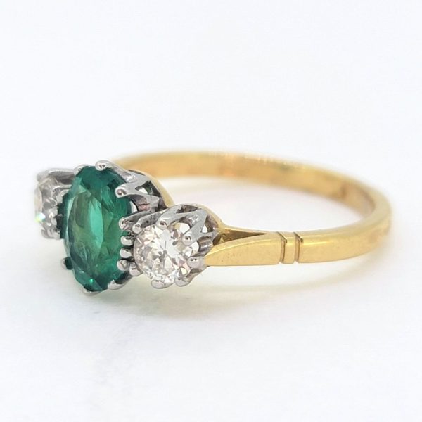 1.10ct Oval Emerald and Diamond Three Stone Engagement Ring, oval-cut emerald flanked by sparkling round brilliant-cut diamonds in 18ct gold