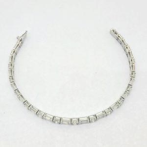 6.40ct Baguette and Brilliant Cut Diamond Line Tennis Bracelet, set with 6.40 carats of round brilliant-cut and baguette-cut diamonds in 18ct white gold. 17cm