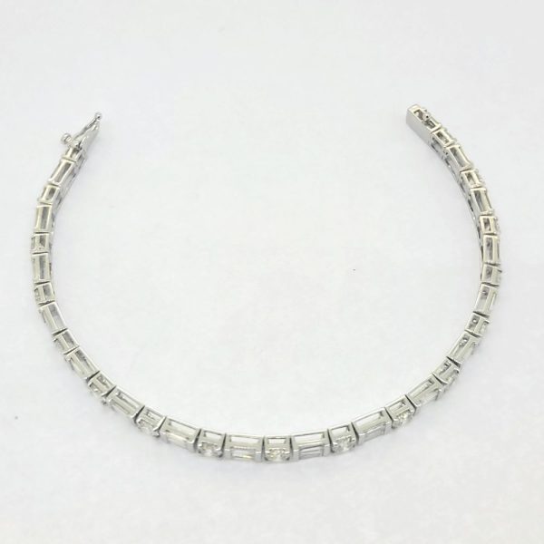 6.40ct Baguette and Brilliant Cut Diamond Line Tennis Bracelet, set with 6.40 carats of round brilliant-cut and baguette-cut diamonds in 18ct white gold. 17cm