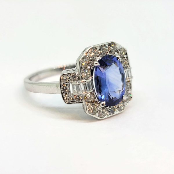 2ct Oval Sapphire and Diamond Cluster Ring, 2.02ct oval blue sapphire surrounded by diamonds with diamond buckle design shoulders