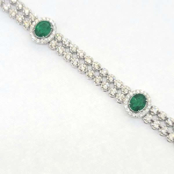 2.24ct Emerald and 3.45ct Diamond Bracelet, double row of sparkling diamonds interspersed with emerald and diamond cluster accents in 18ct white gold