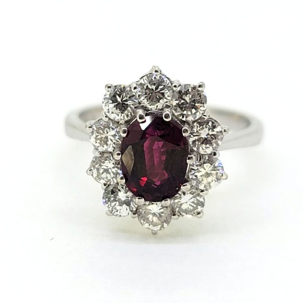 Natural No Heat Ruby and Diamond Cluster Engagement Ring, oval-cut Thai ruby with no indication of heat treatment surrounded by 1ct sparkling round brilliant-cut diamonds in 18ct white gold