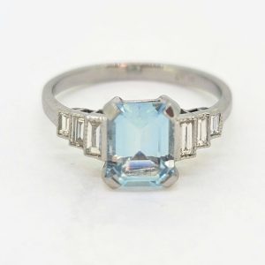 1.20ct Aquamarine and Diamond Engagement Ring in Platinum, 1.20ct emerald-cut aquamarine flanked by graduated stepped baguette-cut diamonds to the sides