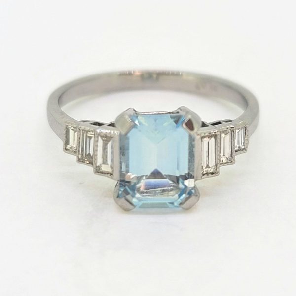 1.20ct Aquamarine and Diamond Engagement Ring in Platinum, 1.20ct emerald-cut aquamarine flanked by graduated stepped baguette-cut diamonds to the sides