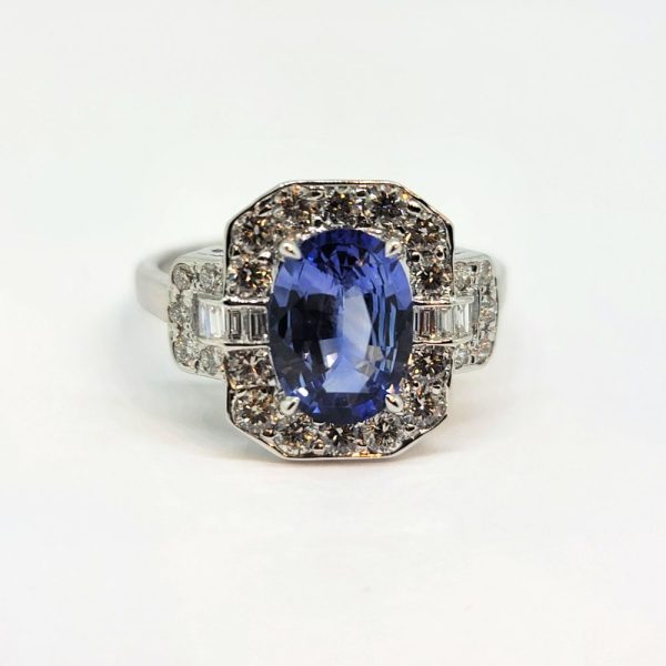 2ct Oval Sapphire and Diamond Cluster Ring, 2.02ct oval blue sapphire surrounded by diamonds with diamond buckle design shoulders