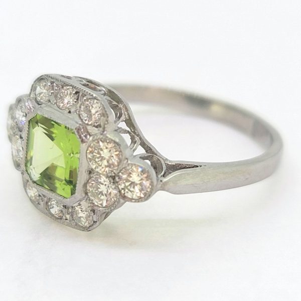 Peridot and Diamond Cluster Engagement Ring in Platinum, 0.90ct octagonal step-cut peridot surrounded by a border of sparkling round brilliant-cut diamonds