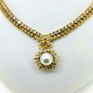 South Sea Pearl and Diamond Pendant Necklace, 10 carat total, 18ct yellow gold necklace set with double row of diamonds with central diamond cluster which suspends the detachable South Sea pearl and baguette-cut diamond cluster pendant drop