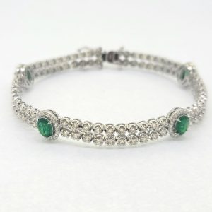 2.24ct Emerald and 3.45ct Diamond Line Tennis Bracelet, double row of sparkling diamonds interspersed with emerald and diamond cluster accents in 18ct white gold