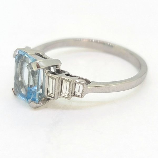 1.20ct Aquamarine and Diamond Engagement Ring in Platinum, 1.20ct emerald-cut aquamarine flanked by graduated stepped baguette-cut diamonds to the sides