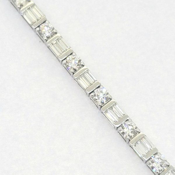 Baguette and Brilliant Cut Diamond Line Tennis Bracelet, set with 6.40 carats of round brilliant-cut and baguette-cut diamonds in 18ct white gold. 17cm