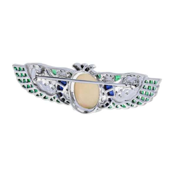 4.51ct Oval Cabochon Ethiopian Opal Emerald Sapphire and Diamond Wing Brooch with Black Enamel in 18ct White Gold