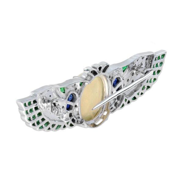 4.51ct Oval Cabochon Ethiopian Opal Emerald Sapphire and Diamond Wing Brooch with Black Enamel in 18ct White Gold