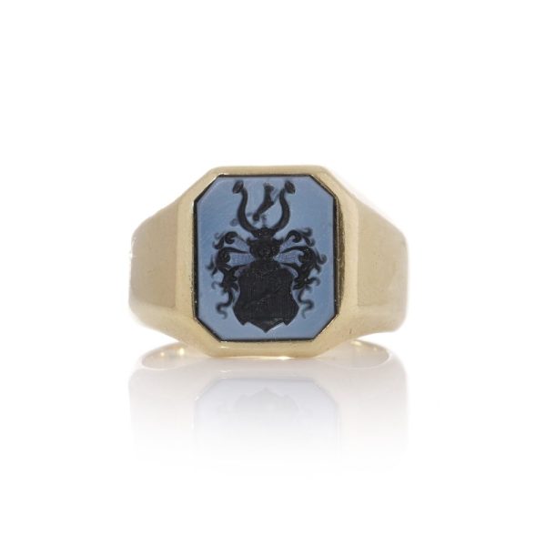 Antique signet ring with family crest and carved sardonyx intaglio.