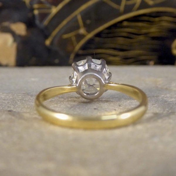 Diamond solitaire ring in yellow and white gold.