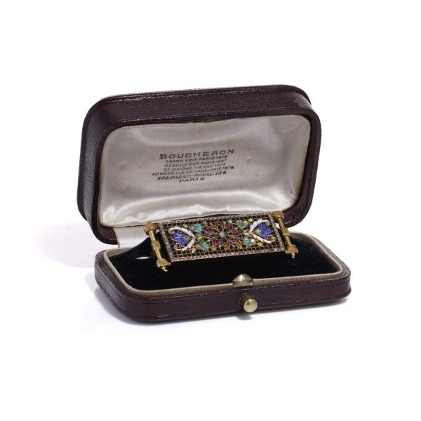 Lingerie pin brooch in gold with enamel and diamonds.