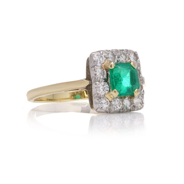 Emerald and diamond cluster ring in gold and platinum.