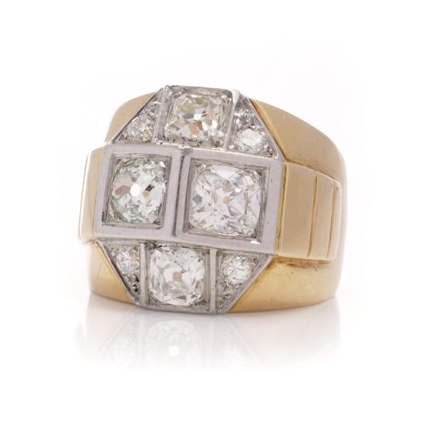 Diamond dome ring in gold and platinum. 