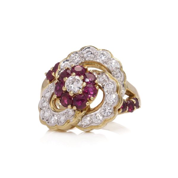 Flower-shaped diamond and ruby cluster ring in gold.