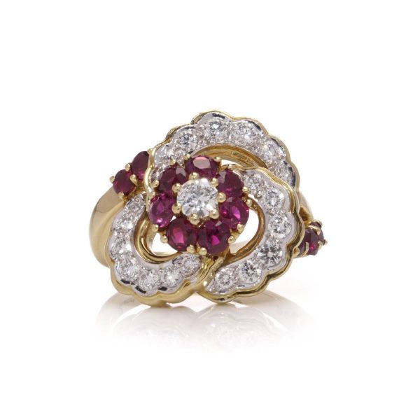 Flower-shaped diamond and ruby cluster ring in gold.