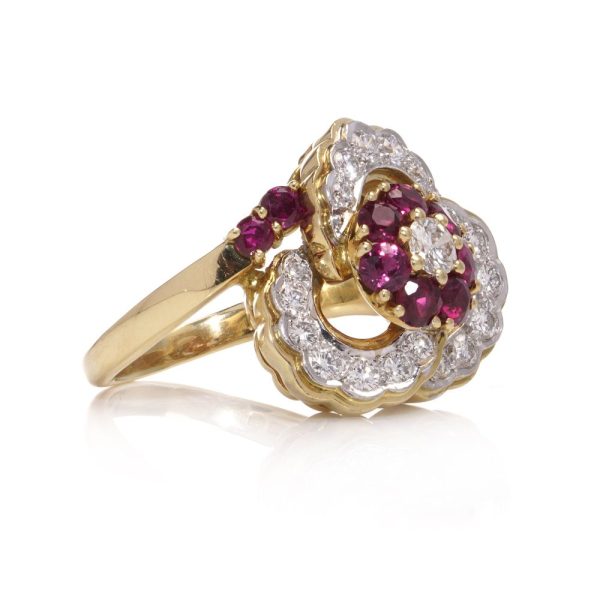 Flower-shaped diamond and ruby cluster ring in gold.