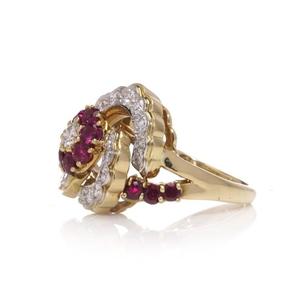 Flower-shaped diamond and ruby cluster ring in gold.