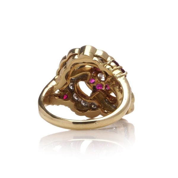 Flower-shaped diamond and ruby cluster ring in gold.