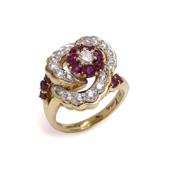 Flower-shaped diamond and ruby cluster ring in gold.