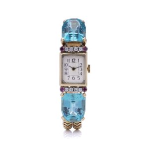 Ladies gold cocktail watch with Gemstones.