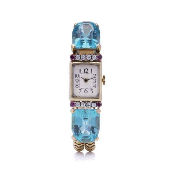 Ladies gold cocktail watch with Gemstones.