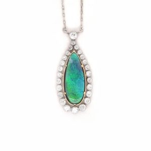 A vintage art deco pear shaped Black opal and diamond platinum pendant.