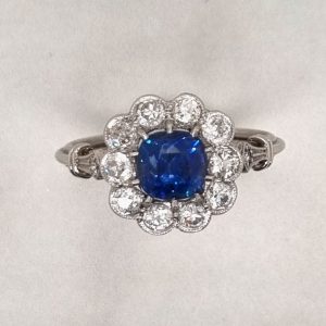 Art-Deco style sapphire and diamond cluster engagement ring in platinum