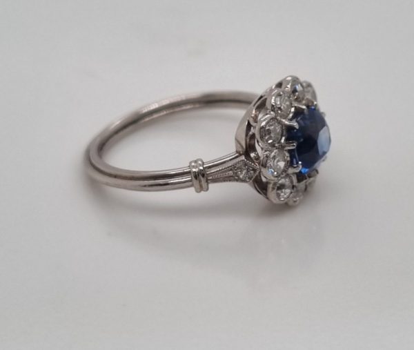 Art-Deco style sapphire and diamond cluster engagement ring in platinum