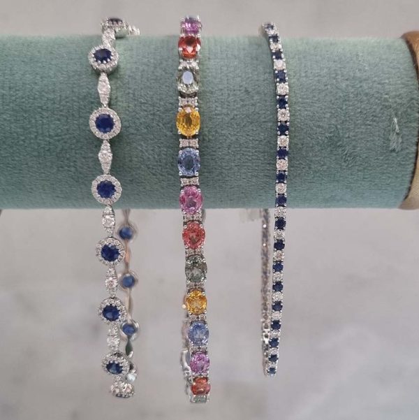 13.44ct Oval Fancy Rainbow Sapphire and Diamond Line Bracelet in 18ct White Gold with orange, yellow, green, pink/purple, and blue sapphires