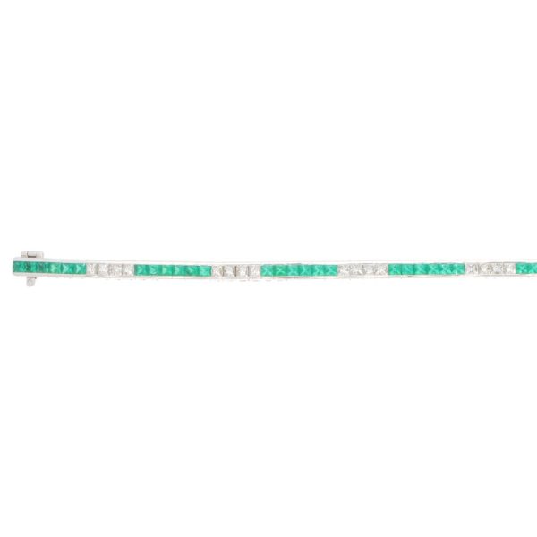 Contemporary 18ct white gold scissor cut emeralds and french cut diamonds line tennis bracelet