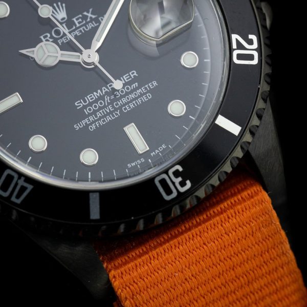 Rolex Submariner Stealth 16610 Black DLC Dial and Orange Strap, 40mm case has been customised with a black diamond like coating and fitted to orange NATO strap