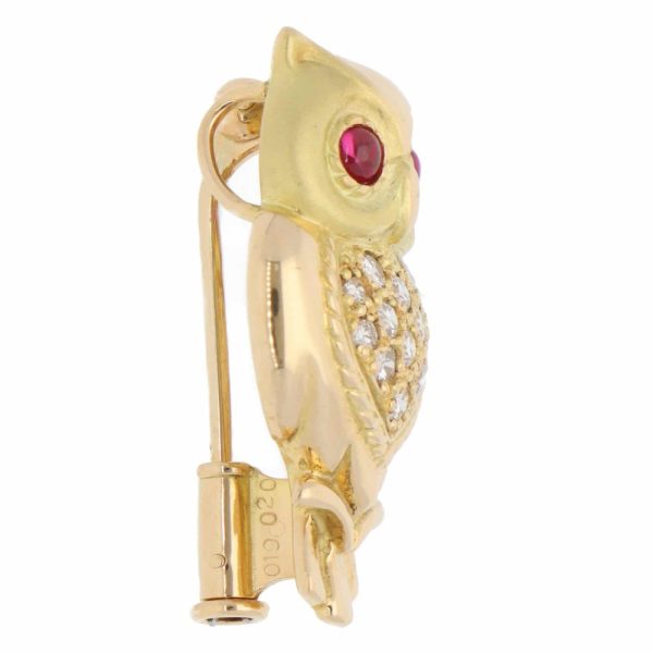 A vintage diamond and ruby owl brooch made in 18ct yellow gold