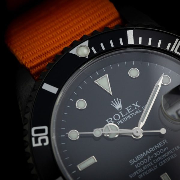 Rolex Submariner Stealth 16610 Black DLC Dial and Orange Strap, 40mm case has been customised with a black diamond like coating and fitted to orange NATO strap