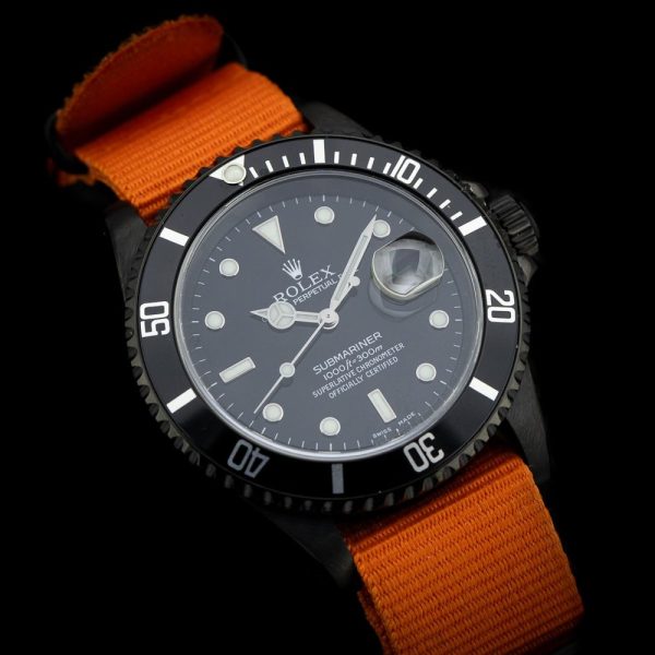 Rolex Submariner Stealth 16610 Black DLC Dial and Orange Strap, 40mm case has been customised with a black diamond like coating and fitted to orange NATO strap