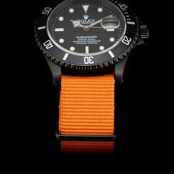 Rolex Submariner Stealth 16610 Black DLC Dial and Orange Strap, 40mm case has been customised with a black diamond like coating and fitted to orange NATO strap